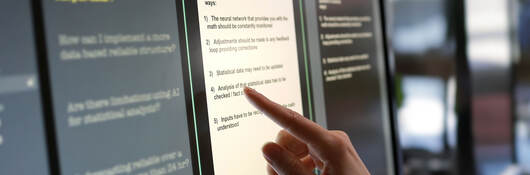A person touching an artificial intelligence touch screen